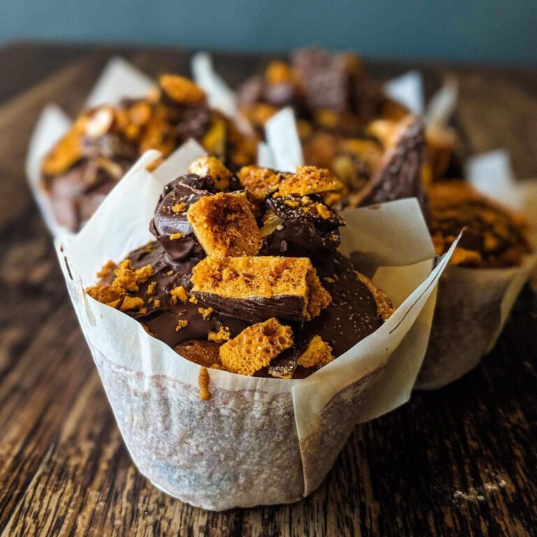 Chocolate honeycomb muffins on a wooden board